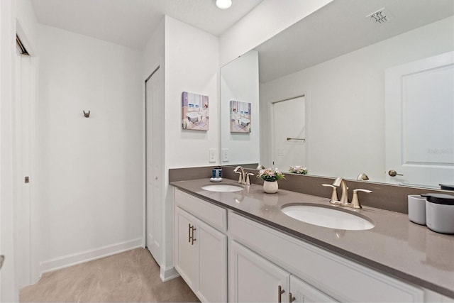 bathroom with tile patterned flooring and double vanity