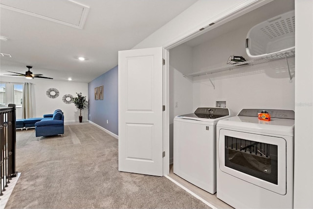 laundry area featuring light carpet, washer and dryer, and ceiling fan