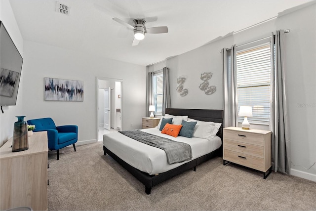 carpeted bedroom featuring ceiling fan and connected bathroom