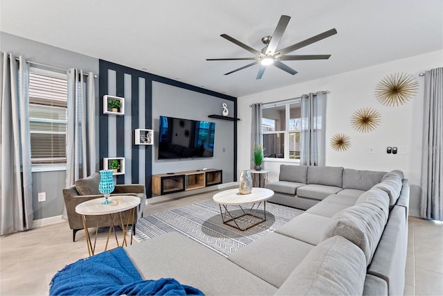 living room featuring ceiling fan and light tile patterned floors