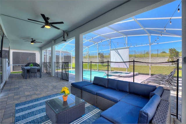 sunroom featuring lofted ceiling and ceiling fan