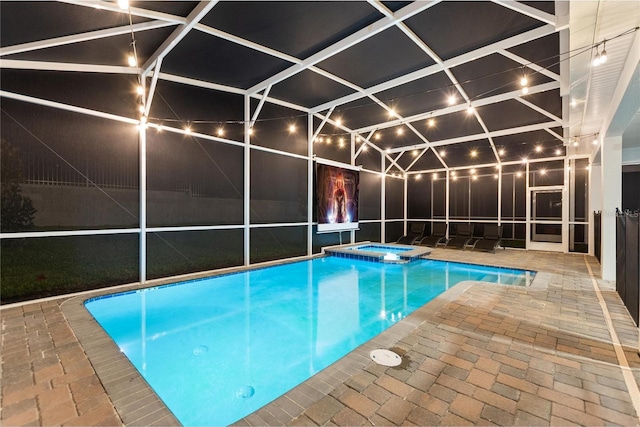 view of pool featuring an in ground hot tub, a patio, and glass enclosure