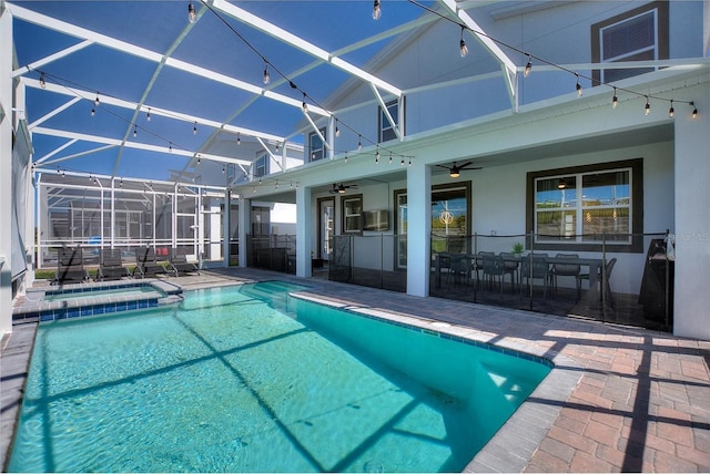 view of pool with a patio, ceiling fan, and glass enclosure