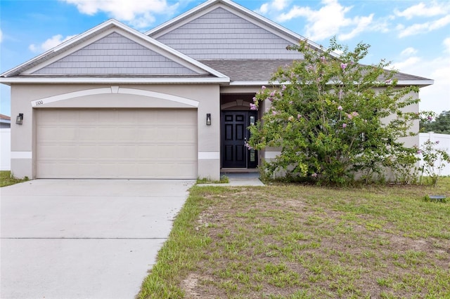 view of front facade featuring a garage and a front lawn