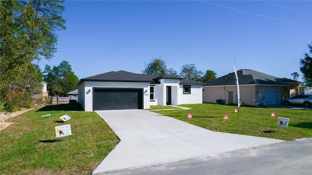 ranch-style home with a garage and a front lawn