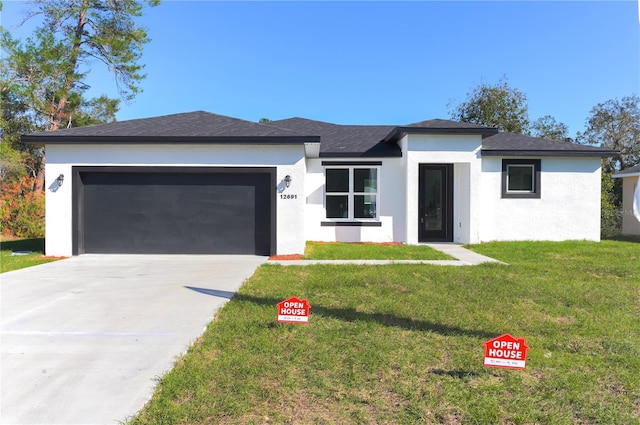 view of front facade with a garage and a front lawn