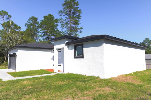 view of front of property with a garage and a front yard