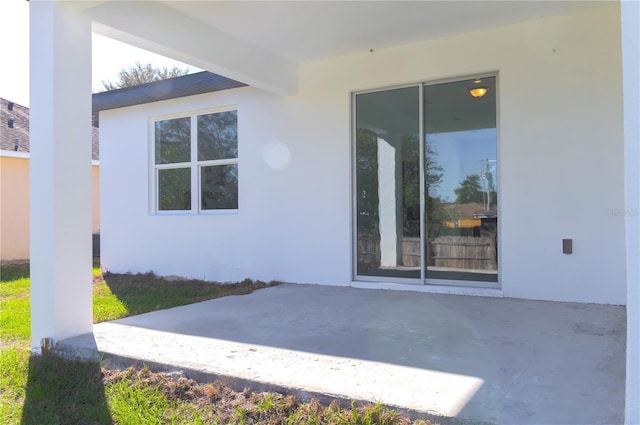 property entrance featuring a patio