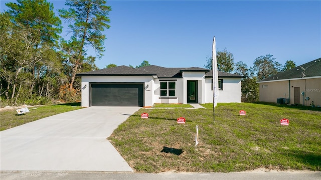 ranch-style house featuring a garage and a front lawn