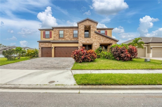 view of front of property with a front yard and a garage