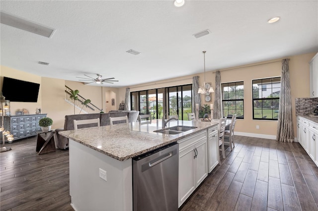 kitchen with visible vents, a sink, dishwasher, dark wood-style floors, and a kitchen island with sink