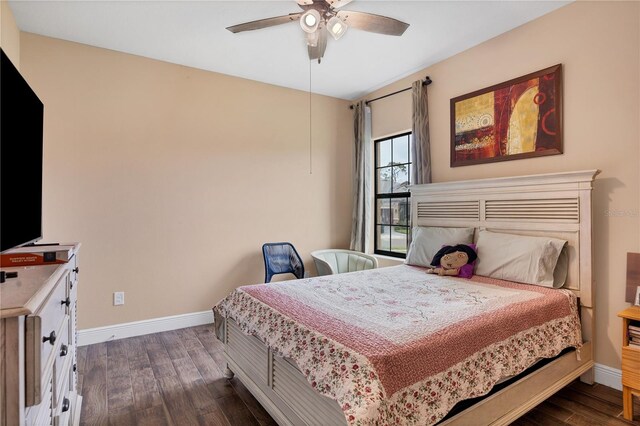 bedroom with dark wood-type flooring, baseboards, and ceiling fan