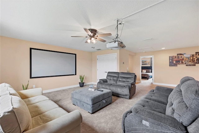 cinema room with baseboards, a ceiling fan, and carpet flooring