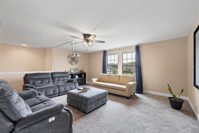 living room featuring baseboards, carpet, and a textured ceiling