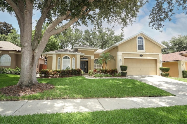 view of front of home with a garage and a front lawn