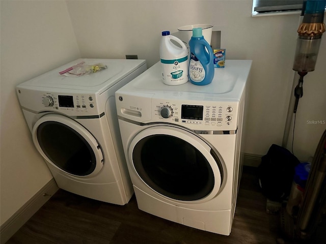 laundry area featuring washing machine and dryer and dark hardwood / wood-style flooring