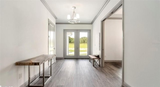 doorway to outside with french doors, an inviting chandelier, crown molding, and wood-type flooring