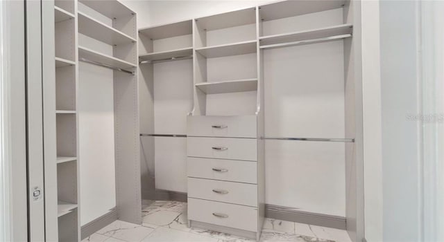 walk in closet featuring light tile patterned flooring