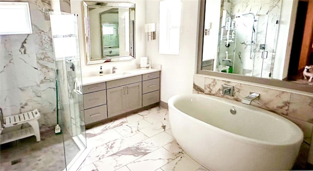 bathroom with tile patterned floors, independent shower and bath, plenty of natural light, and vanity