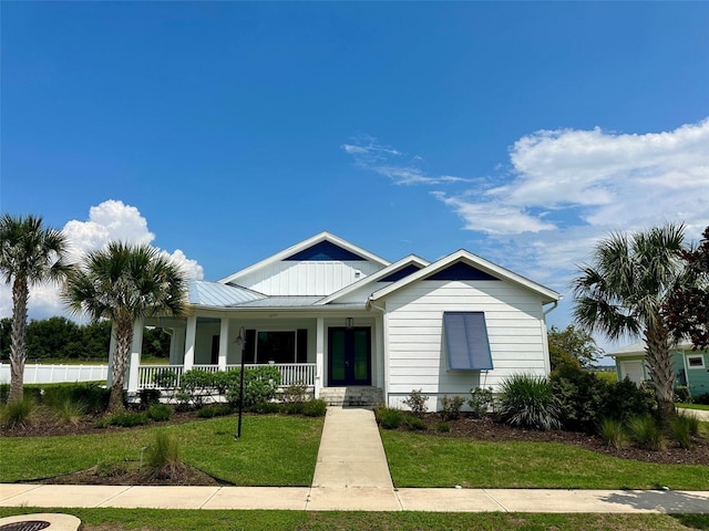 view of front of house featuring covered porch and a front yard