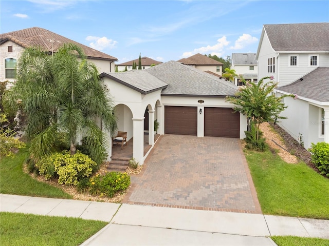 view of front of property featuring a garage and a front yard