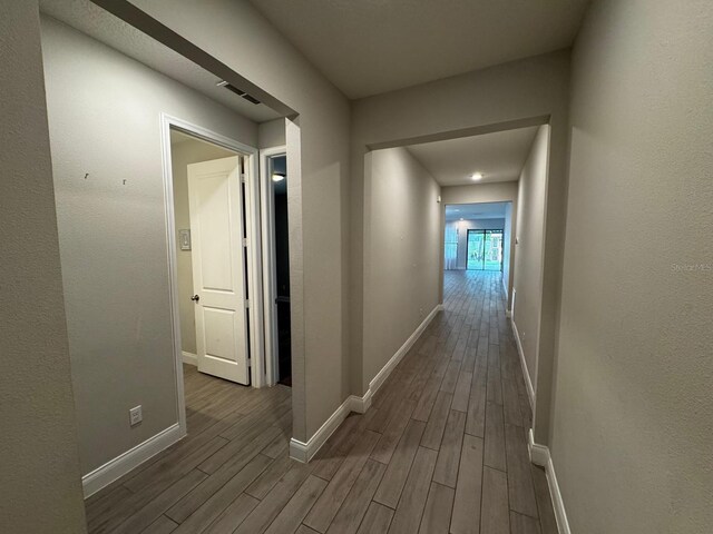 corridor with dark wood-type flooring