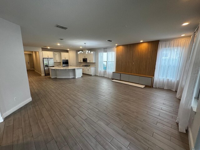 unfurnished living room with hardwood / wood-style floors