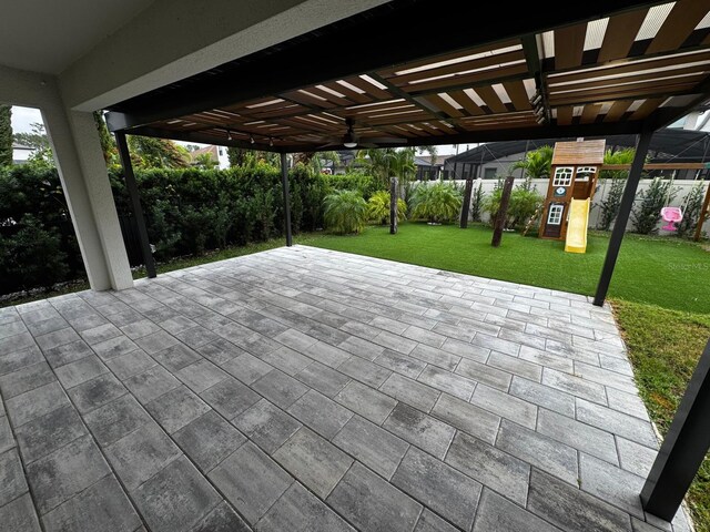 view of patio / terrace featuring a pergola and a playground