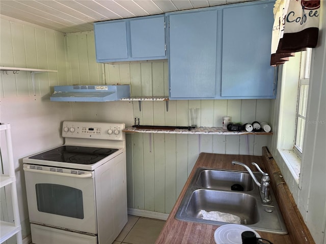 kitchen featuring wood walls, tile patterned floors, sink, white electric range oven, and extractor fan