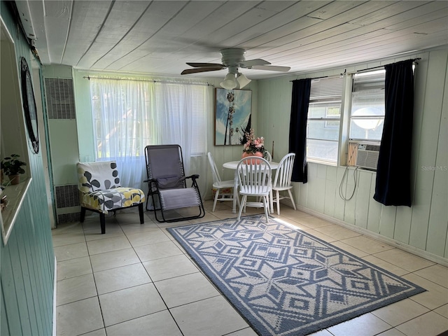 sitting room with ceiling fan, cooling unit, wood ceiling, and light tile patterned floors