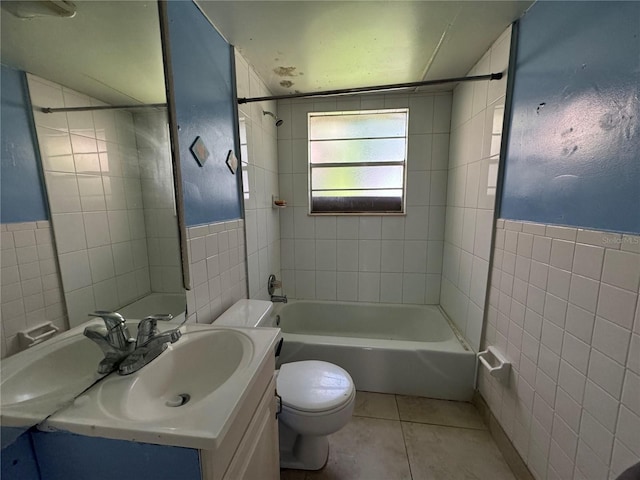 full bathroom with tile patterned flooring, vanity, toilet, and tile walls