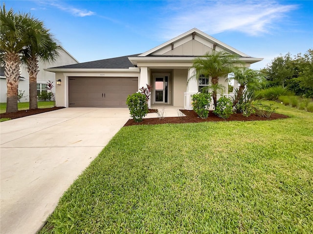 view of front of property with a front yard and a garage