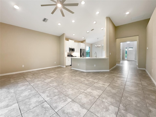 unfurnished living room with ceiling fan with notable chandelier, sink, light tile patterned floors, and lofted ceiling