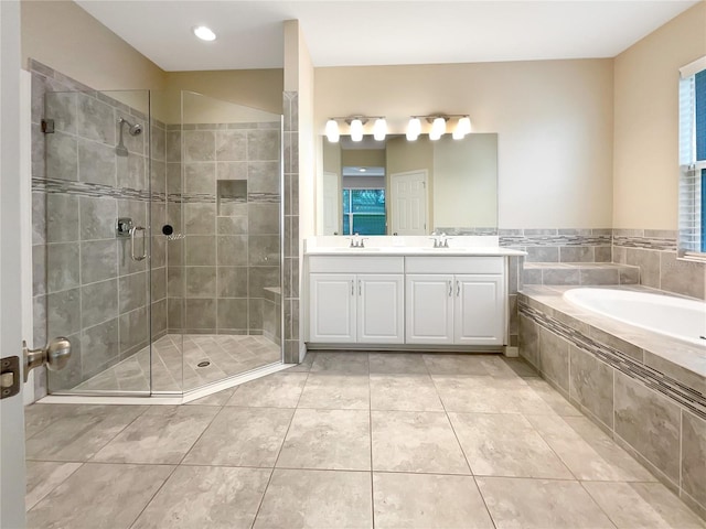 bathroom featuring vanity, shower with separate bathtub, and tile patterned flooring