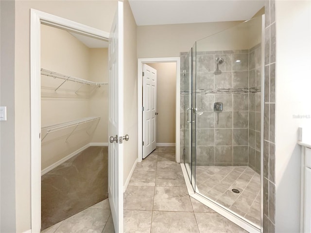 bathroom featuring vanity, tile patterned floors, and a shower with shower door