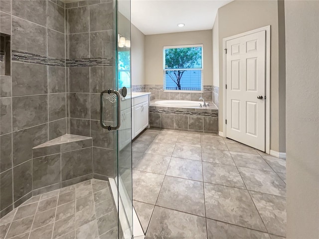 bathroom featuring vanity, tile patterned floors, and separate shower and tub