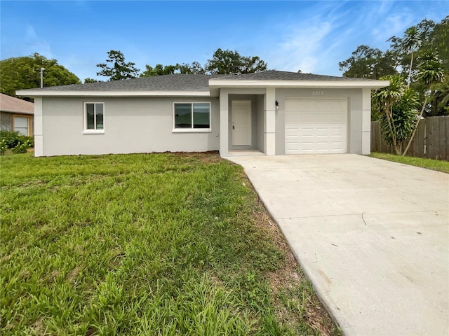 single story home with a garage and a front yard