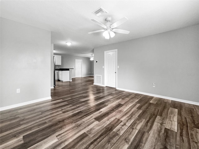 unfurnished living room featuring ceiling fan and dark hardwood / wood-style flooring