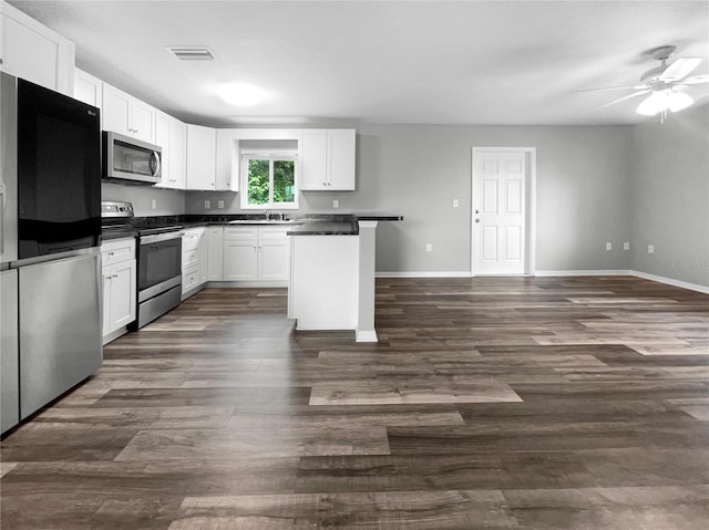 kitchen featuring stainless steel appliances, ceiling fan, dark hardwood / wood-style floors, white cabinets, and sink