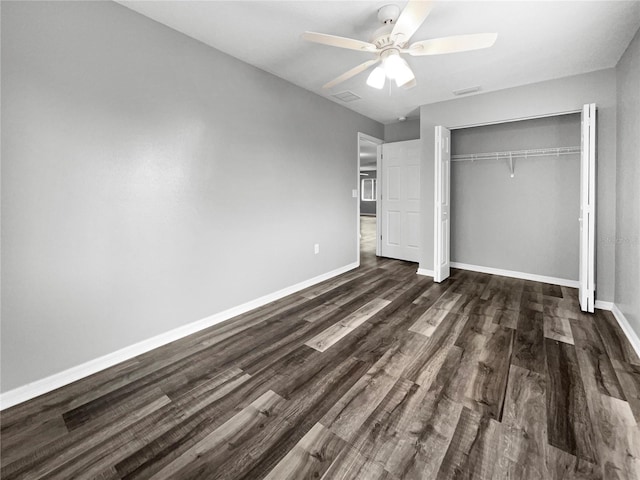 unfurnished bedroom featuring ceiling fan, dark hardwood / wood-style flooring, and a closet