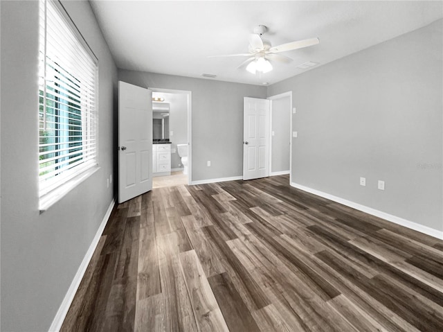 empty room with ceiling fan and dark wood-type flooring