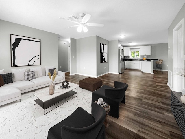 living room with ceiling fan and hardwood / wood-style floors