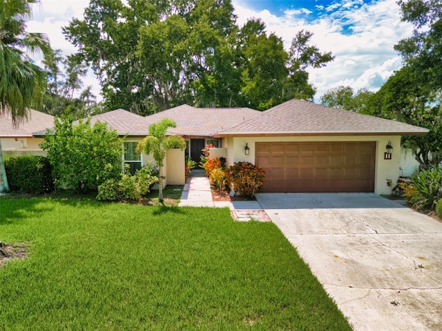 ranch-style home featuring a garage and a front lawn