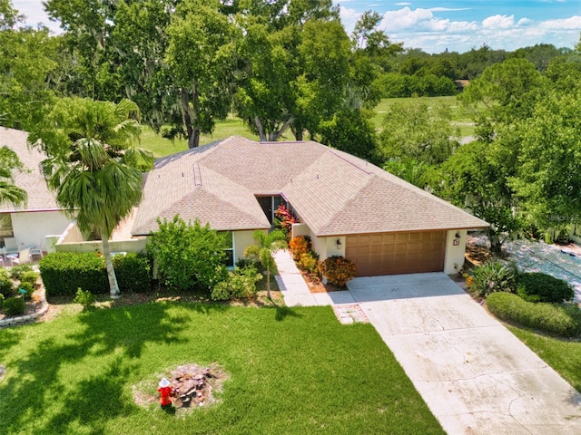 view of front of property with a garage and a front yard