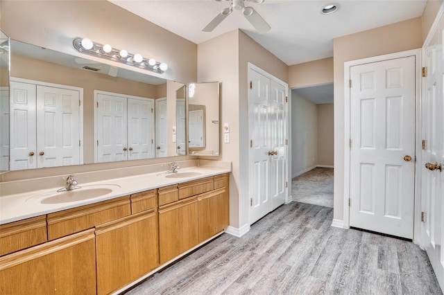 bathroom with vanity, hardwood / wood-style floors, and ceiling fan