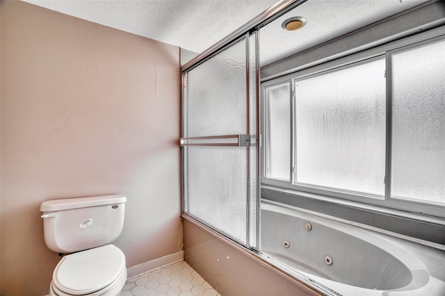 bathroom with bath / shower combo with glass door, tile patterned floors, and toilet