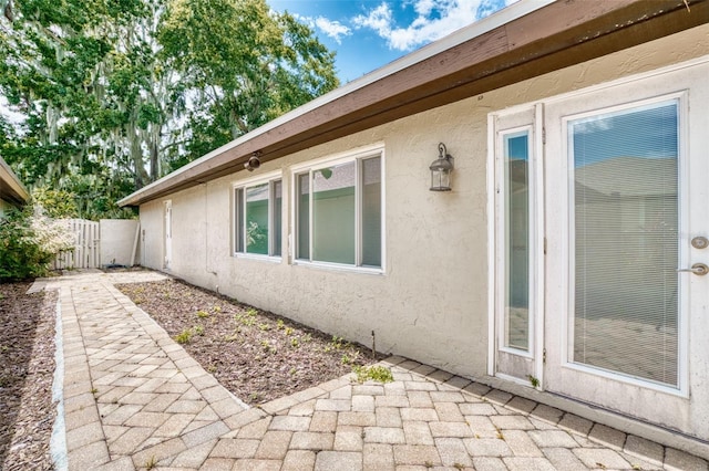 view of side of home with a patio area