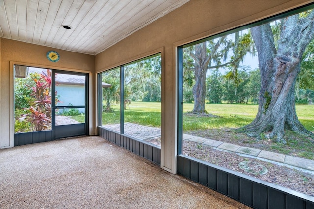 unfurnished sunroom with wood ceiling and a wealth of natural light