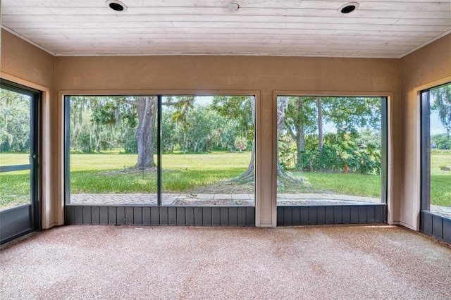 unfurnished sunroom with plenty of natural light and wooden ceiling