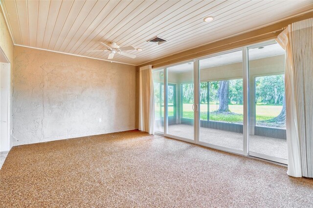 unfurnished room with wooden ceiling and ceiling fan